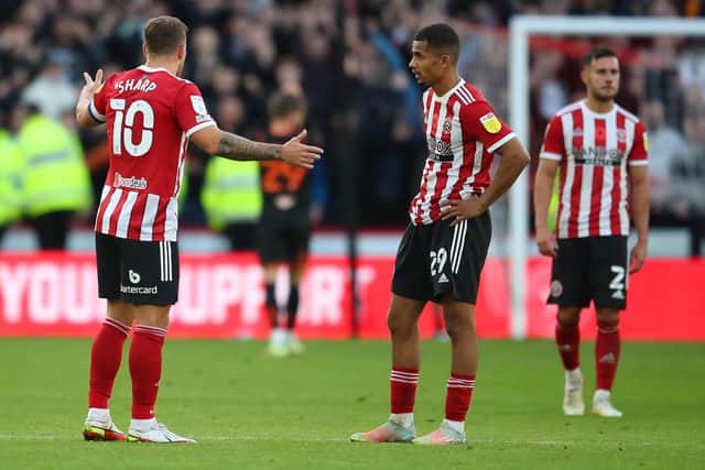 Frustration: Sheffield United’s Billy Sharp, left, and Iliman Ndiaye show their disappointment after defeat to Blackpool at Bramall Lane.