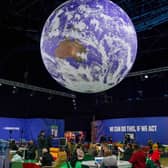 A giant globe hangs from the ceiling as delegates attend on day one of the COP 26 United Nations Climate Change Conference on October 31, 2021 in Glasgow, Scotland. 2021 sees the 26th United Nations Climate Change Conference. (Photo by Ian Forsyth/Getty Images).