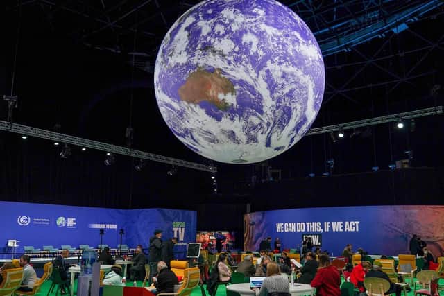 A giant globe hangs from the ceiling as delegates attend on day one of the COP 26 United Nations Climate Change Conference on October 31, 2021 in Glasgow, Scotland. 2021 sees the 26th United Nations Climate Change Conference. (Photo by Ian Forsyth/Getty Images).