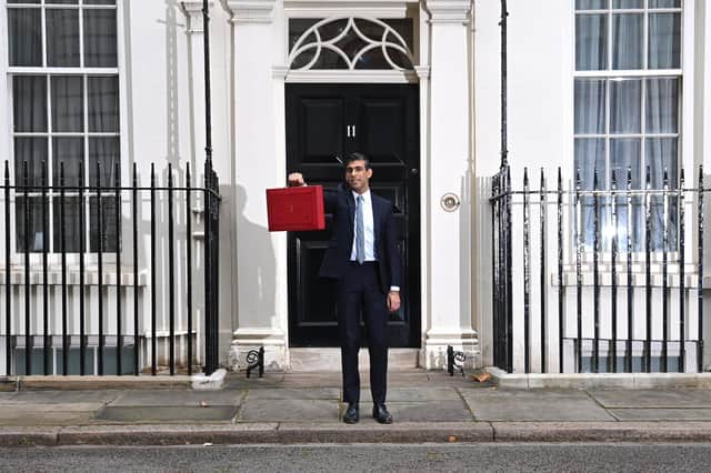 Chancellor Of The Exchequer, Rishi Sunak stands with the Budget Box outside 11 Downing Street, ahead of presenting his Autumn Budget and Spending Review to Parliament, on October 27, 2021 in London. Photo by Leon Neal/Getty Images.