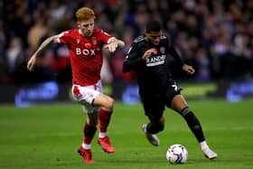 KEEP GOING: Sheffield United's Rhian Brewster, right, battles with Nottingham Forest's Jack Colback at the City Ground on Tuesday. Picture: Simon Marper/PA