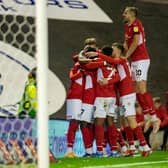 WINNER: Barnsley's players celebrate Aaron Leya Iseka's third goal in as many games