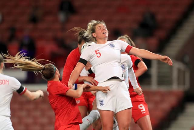 England's Millie Bright (5) jumps to win the ball in a crowded penalty area during the women's international friendly match at the bet365 Stadium, Stoke. (Picture: PA)