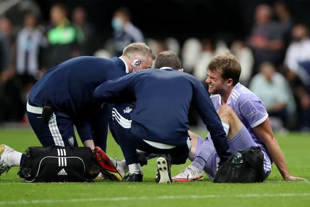 INJURY: Patrick Bamford's ankle injury is treated on the pitch at Newcastle United
