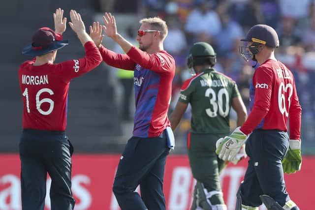 England's captain Eoin Morgan, left, congratulates team-mate Liam Livingstone after taking the wicket of Bangladesh's captain Mohammad Mahmudullah during the Cricket Twenty20 World Cup match. (AP Photo/Aijaz Rahi)