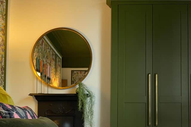 The guest bedroom with wardrobes in Olive paint by Little Greene and the mirror from William Wood Mirrors