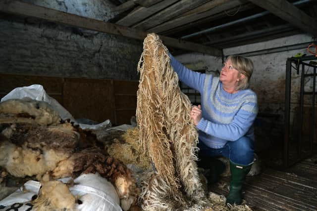 Kath Hume sorts fleeces in a local farmer's barn