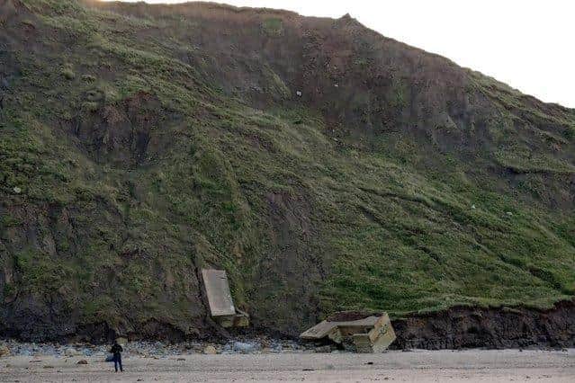 Pillbox remains at the base of the cliff on the beach have been there for many years.