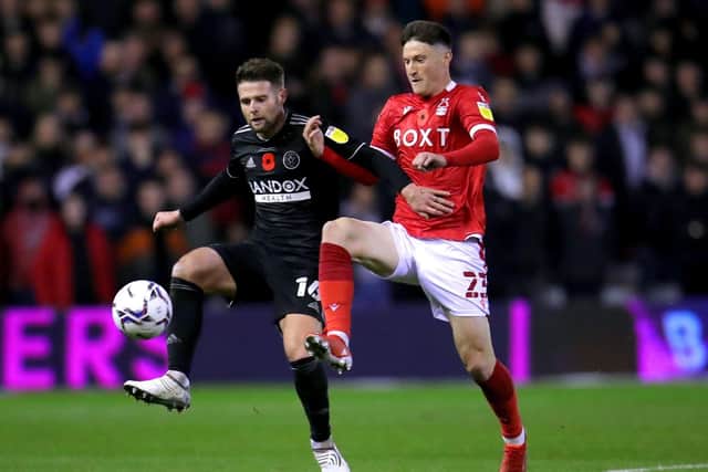 Sheffield United's Oliver Norwood (left) and Nottingham Forest's Joe Lolley battle for the ball during the Sky Bet Championship match at City Ground last week (Picture: PA)