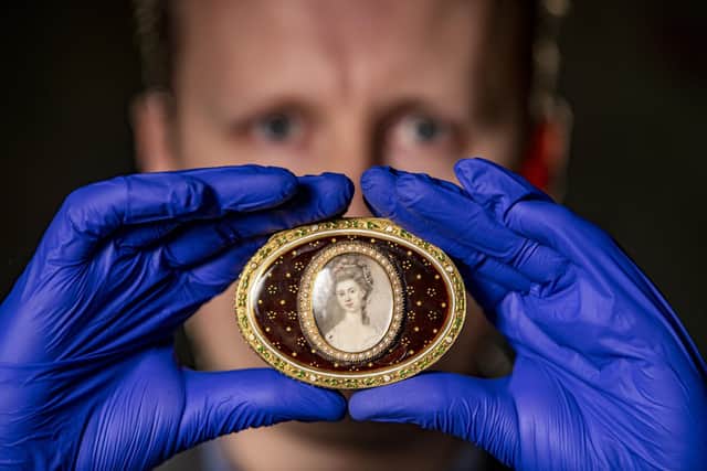 Adam Toole, curator at Temple Newsam House in Leeds with one of the 18th Century golden snuff boxes. Image by Tony Johnson.