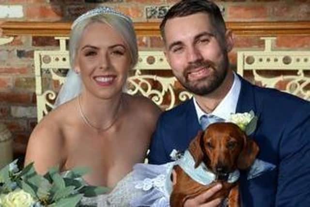 Peggy the dachshund with her owners Chloe and Daniel Smith