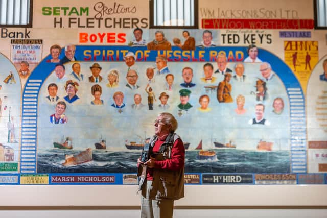 Alec Gill in front of a mural on the wall inside The Edinburgh Road Community Centre, where his portrait has been alongside other well known local people. (James Hardisty).
