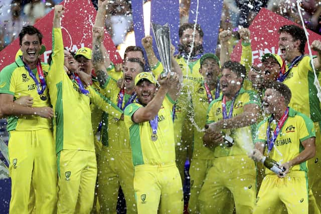 Australia's captain Aaron Finch raises the trophy with his team-mates after winning the Twenty20 World Cup final against New Zealand in Dubai, Australia winning by 8 wickets. Picture: AP/Kamran Jebreili