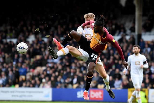 UP FOR IT: Bradford's Theo Robinson battles with  Port Vale's Nathan Smith Picture: Simon Hulme.