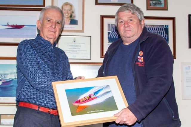 RNLI operations manager David Freeman presents a framed photograph to Mr Wraith. Photo by Rod Newton