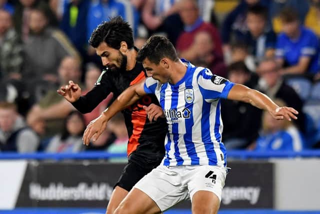 Everton's Andre Gomes battles with Huddersfield Town's Matty Pearson during the Carabao Cup second round match at John Smiths' Stadium (Picture: PA)