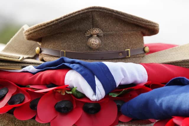 A cap on one of the coffins as nine British soldiers who served and died in battle of Passchendaele during the First World War