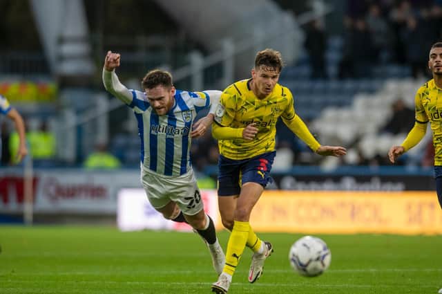 Huddersfield Town's Ollie Turton goes down under pressure from West Brom's Conor Townsend. Picture: Tony Johnson.