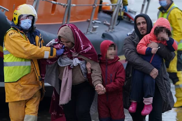 .A family is helped to shore as a group of people thought to be migrants are brought in to Dungeness, Kent, by the RNLI following a small boat incident in the Channel.