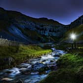 A walker with a head torch at Gordale Scar