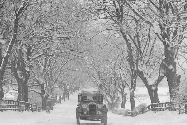A car struggles along a road during the famous winter of 1947