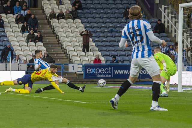 PERFECT TIMING: Huddersfield Town's Daniel Sinani slides in at the pack post to score the winner against West Brom on Saturday. Picture: Tony Johnson