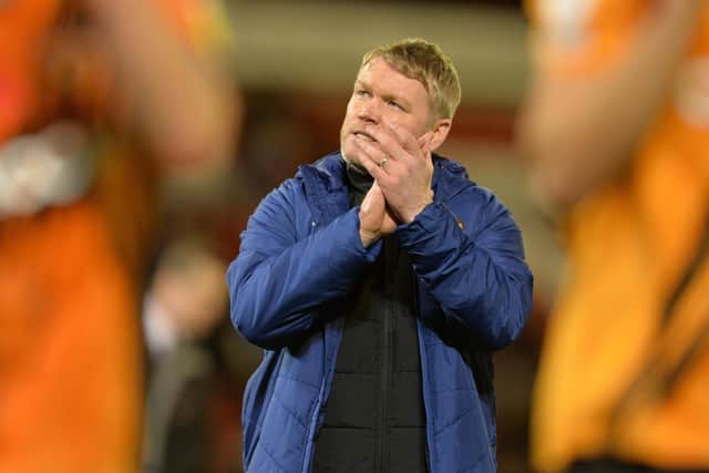 Grant McCann applauds Hull City's fans at full time after seeing his team beat Barnsley at Oakwell. Picture: Bruce Rollinson
