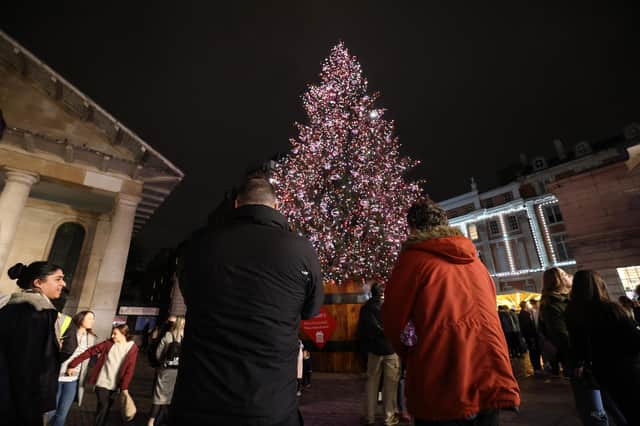 People view the Christmas tree in Covent Garden, London (PA)