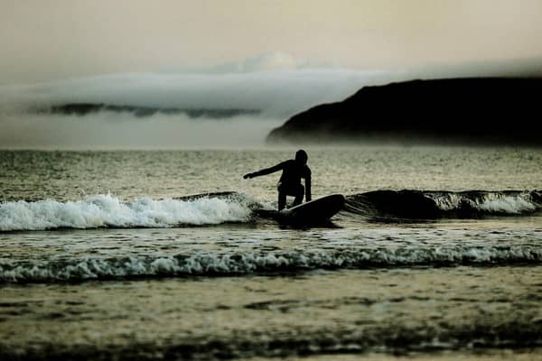 A surfer rides the waves in Scarborough  Picture James Hardisty