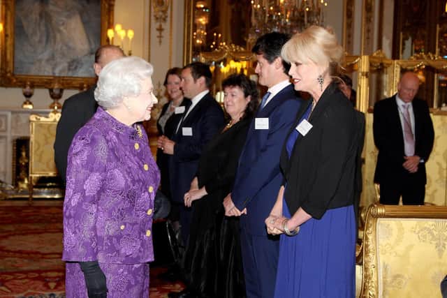 Joanna Lumley meeting the Queen in 2013.