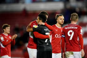 Barnsley's Carlton Morris renews acquaintances with ex-Norwich team-mate and Swansea rival Korey Smith after the final whistle at Oakwell. Picture: PA.