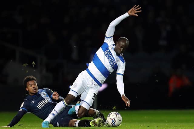 Queens Park Rangers' Albert Adomah (right) and Huddersfield Town's Josh Koroma battle for the ball (Picture: PA)