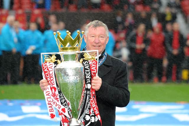 Manchester United manager Sir Alex Ferguson celebrates with the Barclays Premier League trophy, a title he won 13 times with the club (Picture: PA)