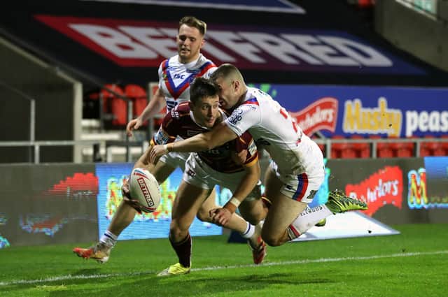 Huddersfield Giants' Sam Wood tackled by Wakefield Trinity's Max Jowitt short of the try line in 2020 (Picture: PA)