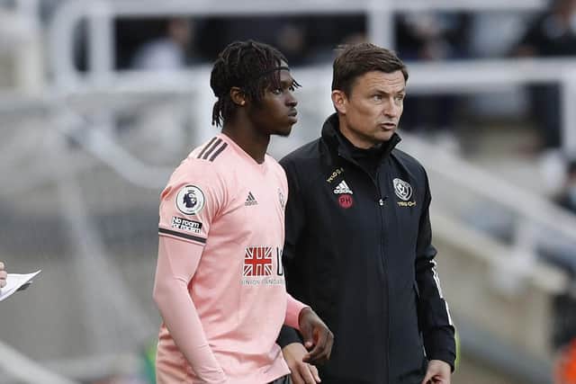COMING BACK: Sheffield United's Femi Seriki waits to make his Blades debut at St James's Park last season, under the watchful gaze of then temporary first-team coach, Paul Heckingbottom Picture: Darren Staples/Sportimage