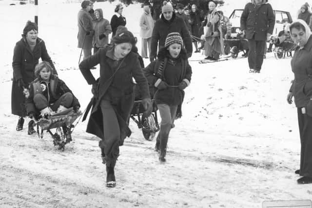 Whitby's winters past... children playing in the snow in wheelbarrows. Image by former press photographer John Tindale, revealed as his old recovered audio tapes are turned into a new film for Whitby Museum.