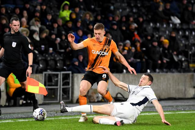 Sliding in: Hull's Greg Doherty is challenged by Millwall player Murray Wallace during the 2-1 success. Picture: Simon Hulme