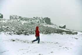 A walker braves the snow on the Cow & Calf on Ilkey Moor Picture: Jonathan Gawthorpe