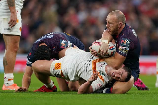 BIG ATTRACTION: Catalans Dragons' Matt Whitley (centre) is tackled by St Helens' Jonny Lomax (left) and James Roby during the Betfred Super League Grand Final at Old Trafford Picture: Martin Rickett/PA