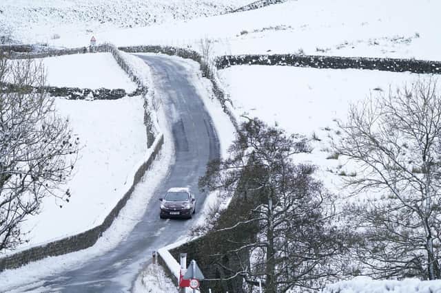A car drives along an icy road through High Green in the Yorkshire Dales, amid freezing conditions in the aftermath of Storm Arwen. PIC: Danny Lawson/PA Wire