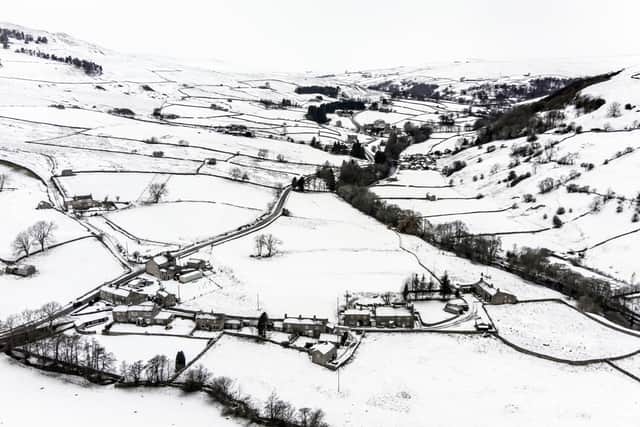 Snow covers fields and hills surround St Mary The Virgin Church in the Arkengarthdale, North Yorkshire, amid freezing conditions in the aftermath of Storm Arwen.