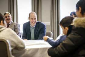 The Duke of Cambridge speaks to refugees during a visit to a local hotel in Leeds, which is being used to accommodate refugees evacuated from Afghanistan.