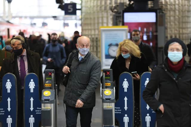 Passengers wearing masks travelling via Waterloo station in London, as mask wearing on public transport becomes mandatory to contain the spread of the Omicron Covid-19 variant