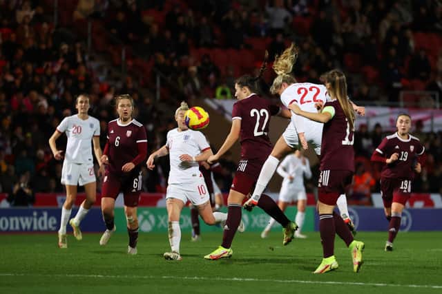 Alessia Russo heads home her second goal in the Lionesses' 20-0 win over Latvia. Pic: Catherine Ivill