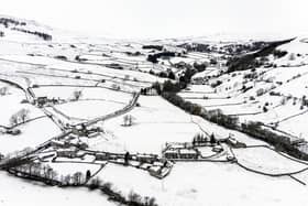 Snow covers fields and hills in the Arkengarthdale valley, North Yorkshire, amid freezing conditions in the aftermath of Storm Arwen (PA)