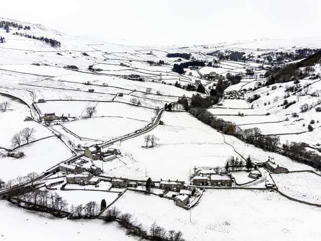Snow covers fields and hills in the Arkengarthdale valley, North Yorkshire, amid freezing conditions in the aftermath of Storm Arwen (PA)