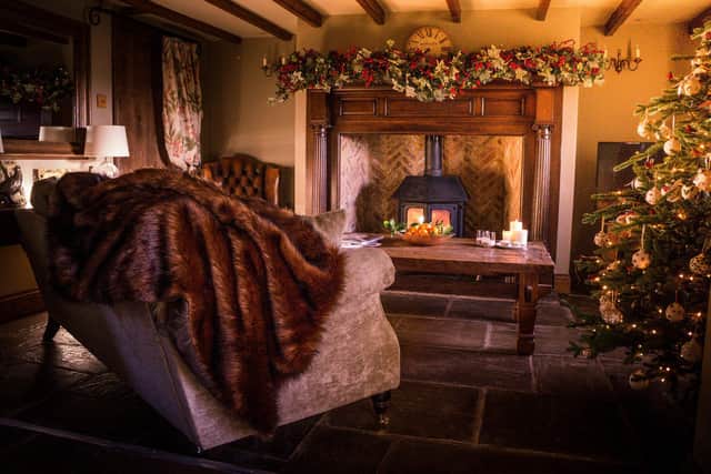 The cosy sitting room is beautifully dressed for Christmas
