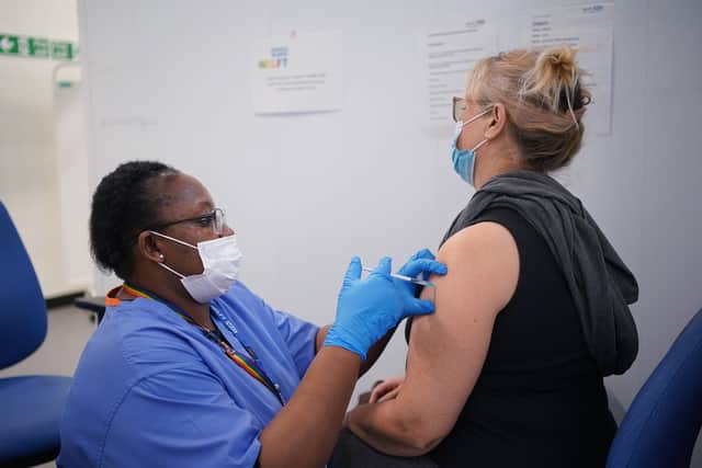 A member of the public receives a Covid jab at a vaccination site  as the Government accelerates the Covid booster programme to help slow down the spread of the new Omicron variant.