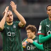 Battling for Barnsley: Michal Helik and Toby Sibbick acknowledge the fans during the Sky Bet Championship match against Fulham at Craven Cottage. Picture: Jacques Feeney/Getty Images