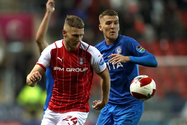 Rotherham United's Michael Smith (left) and Stockport County's Mark Kitching battle for the ball.